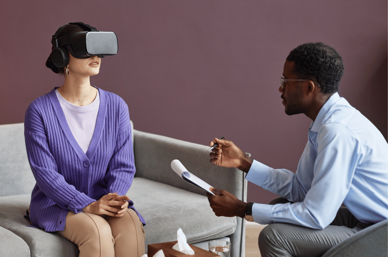 Exposure Therapy Image of a woman wearing a VR headset, speaking with a therapist during exposure therapy